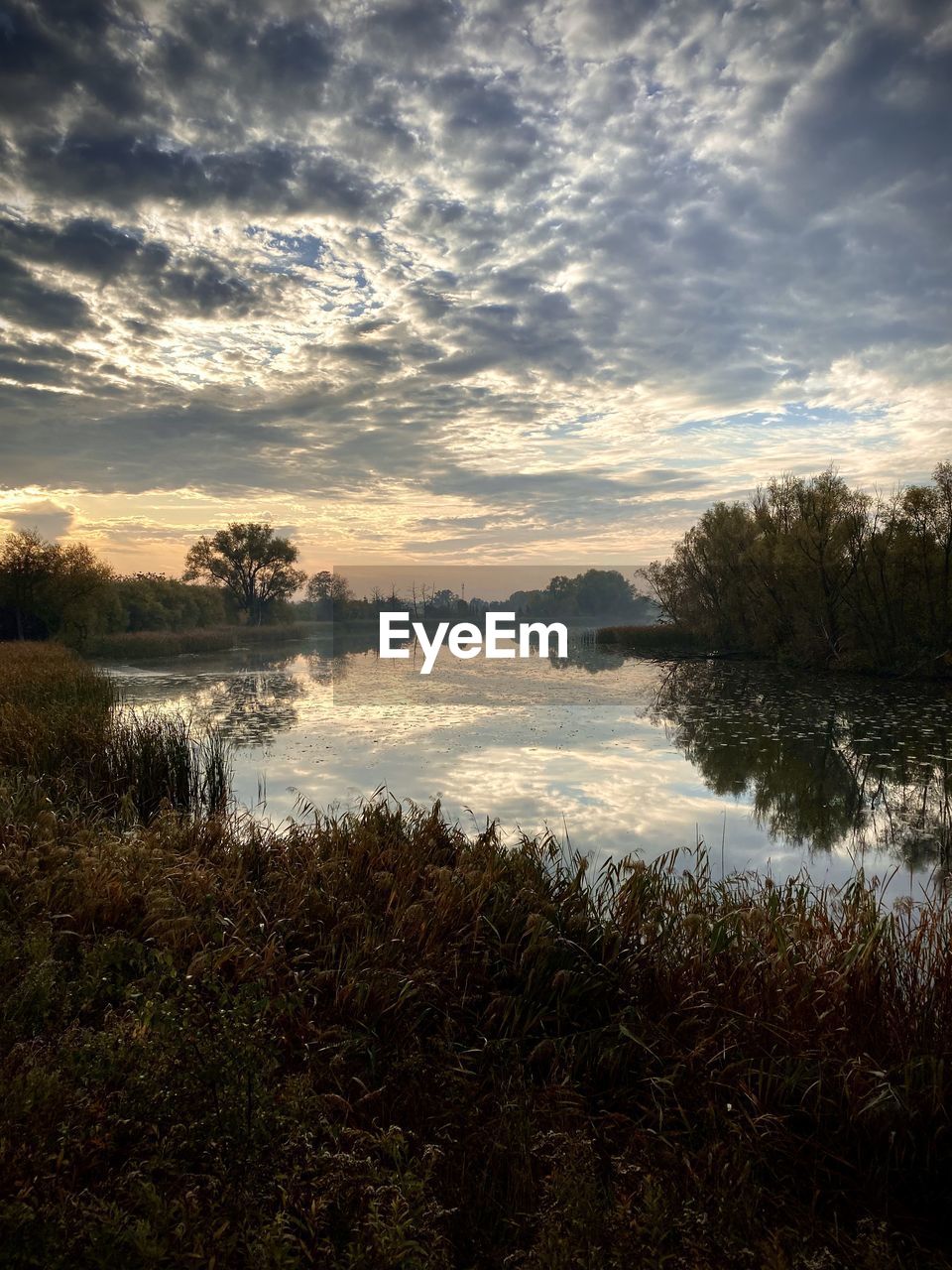 Scenic view of lake against sky during sunset