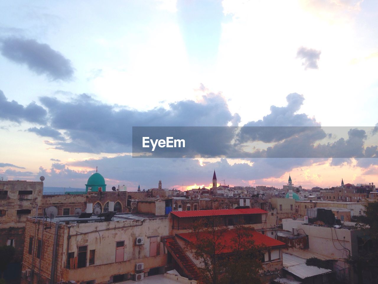 City against sky at sunset