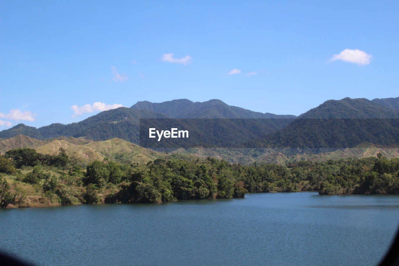 SCENIC VIEW OF MOUNTAINS BY TREES AGAINST SKY