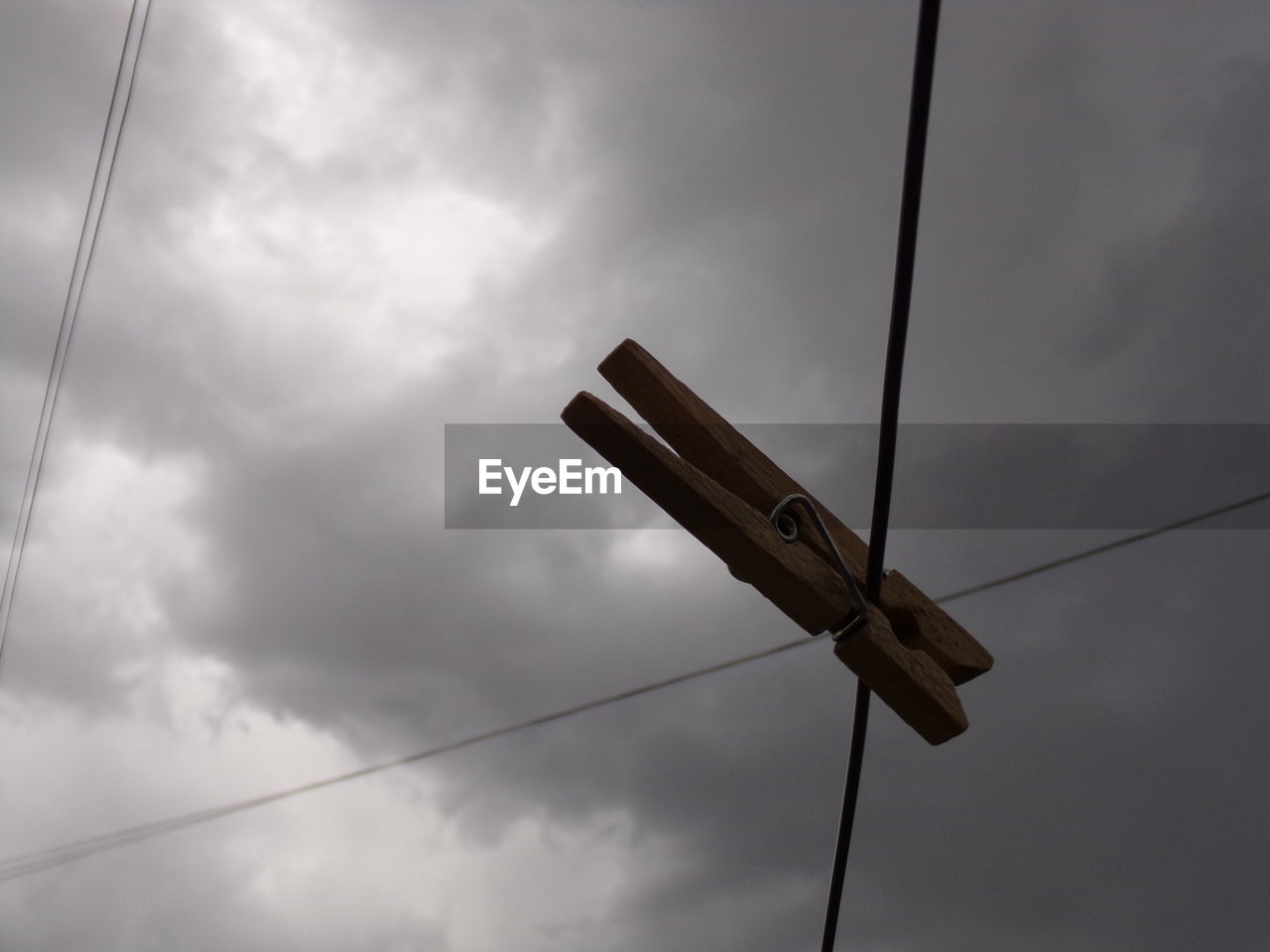 LOW ANGLE VIEW OF POWER LINE AGAINST SKY