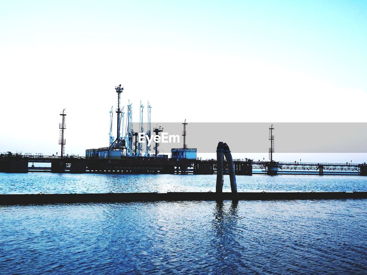 VIEW OF SHIP AT HARBOR AGAINST CLEAR SKY