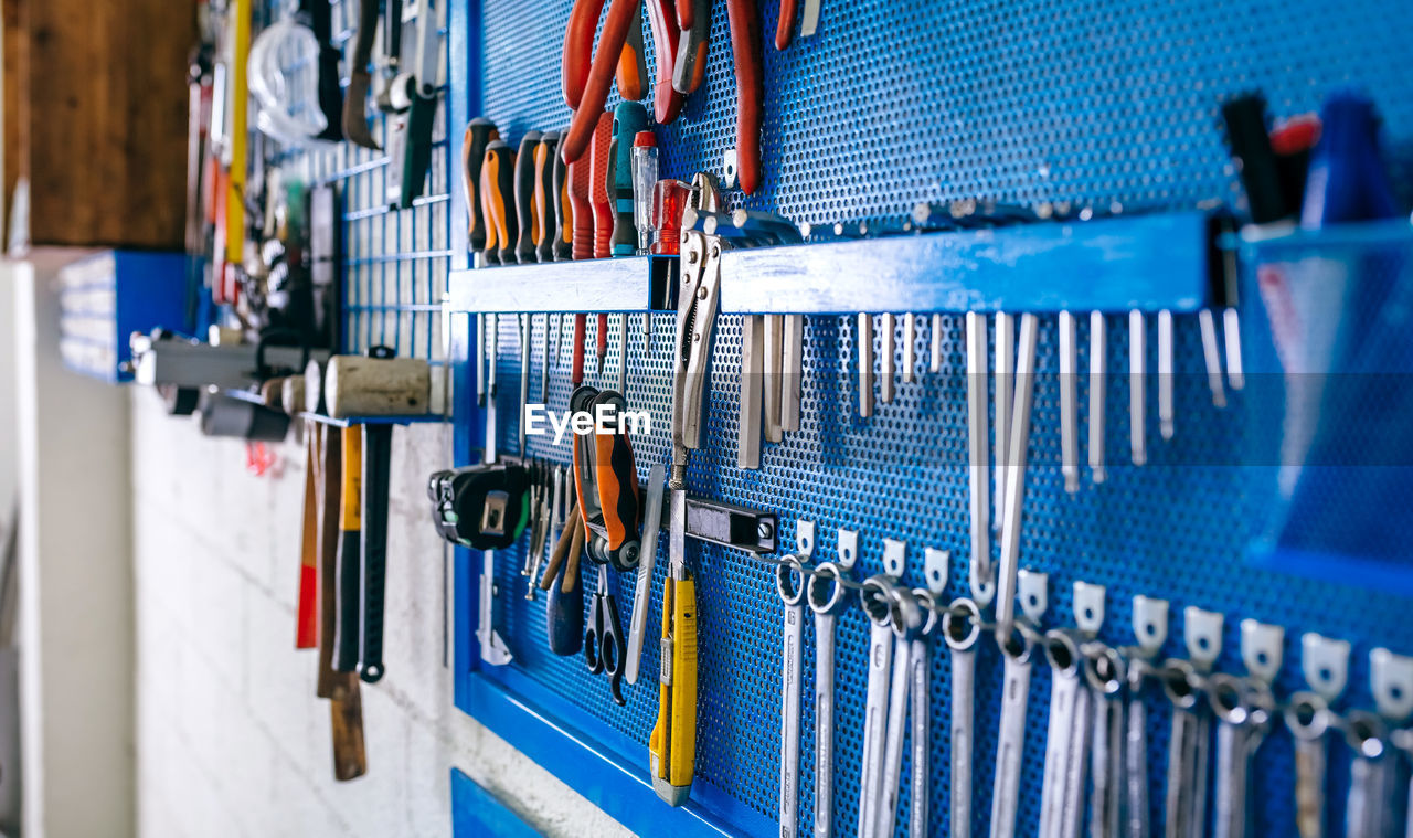 Close-up of work tools hanging at workshop