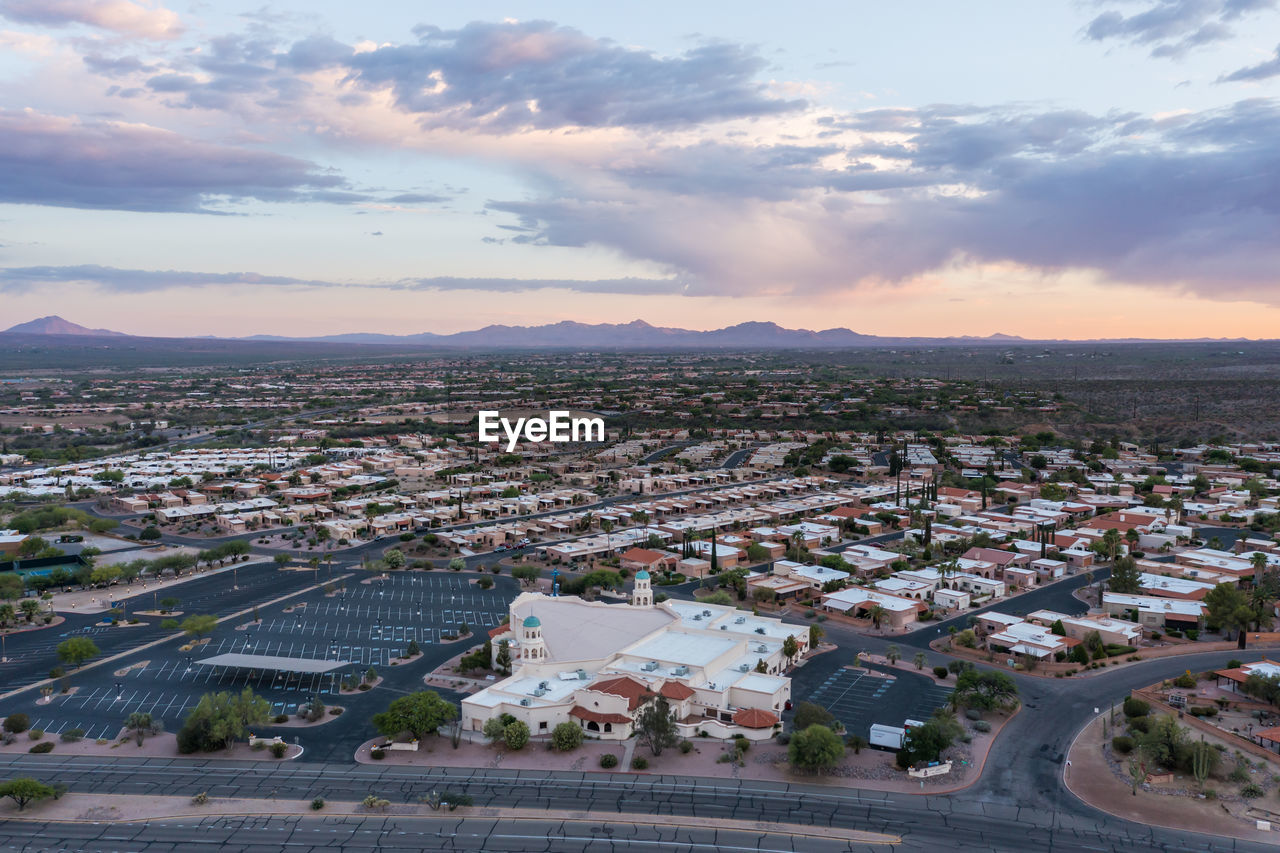 Aerial view of desert hills community with episcopal church in green valley, arizona at sunset 