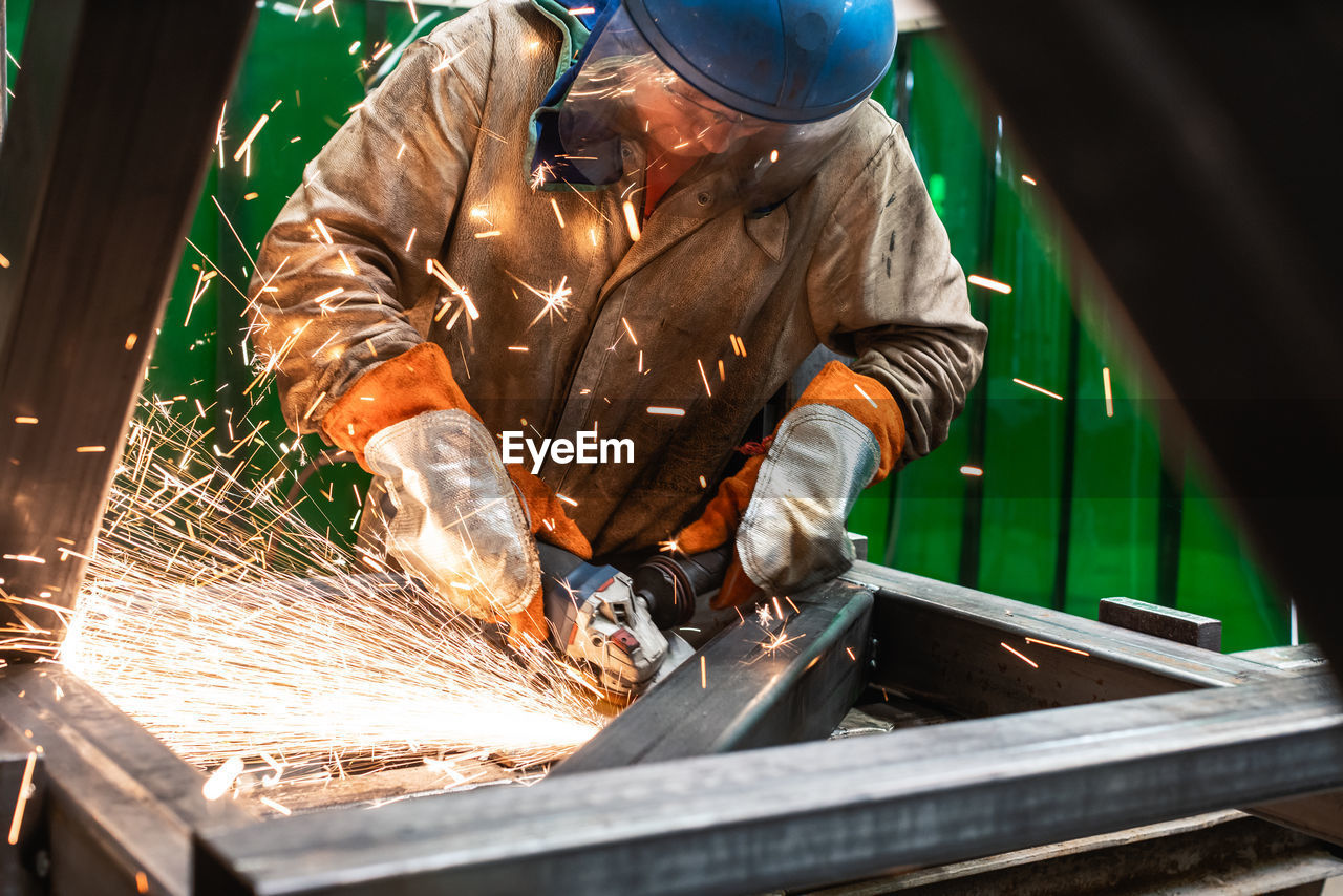 Man cutting metal at workshop