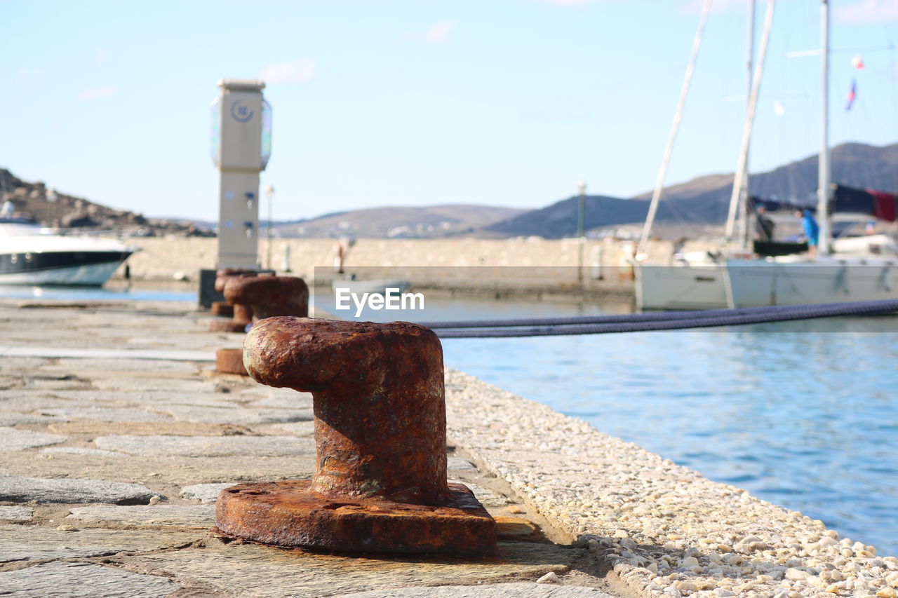 CLOSE-UP OF RUSTY PIER AT HARBOR