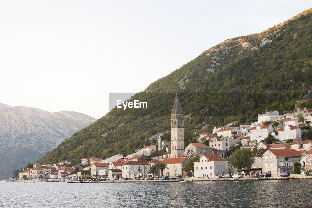 Townscape by sea against sky