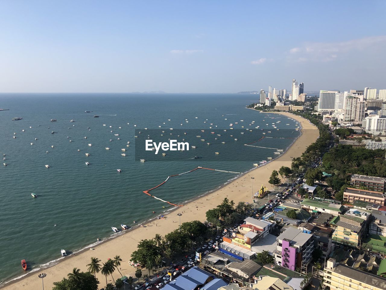 High angle view of city by sea against sky