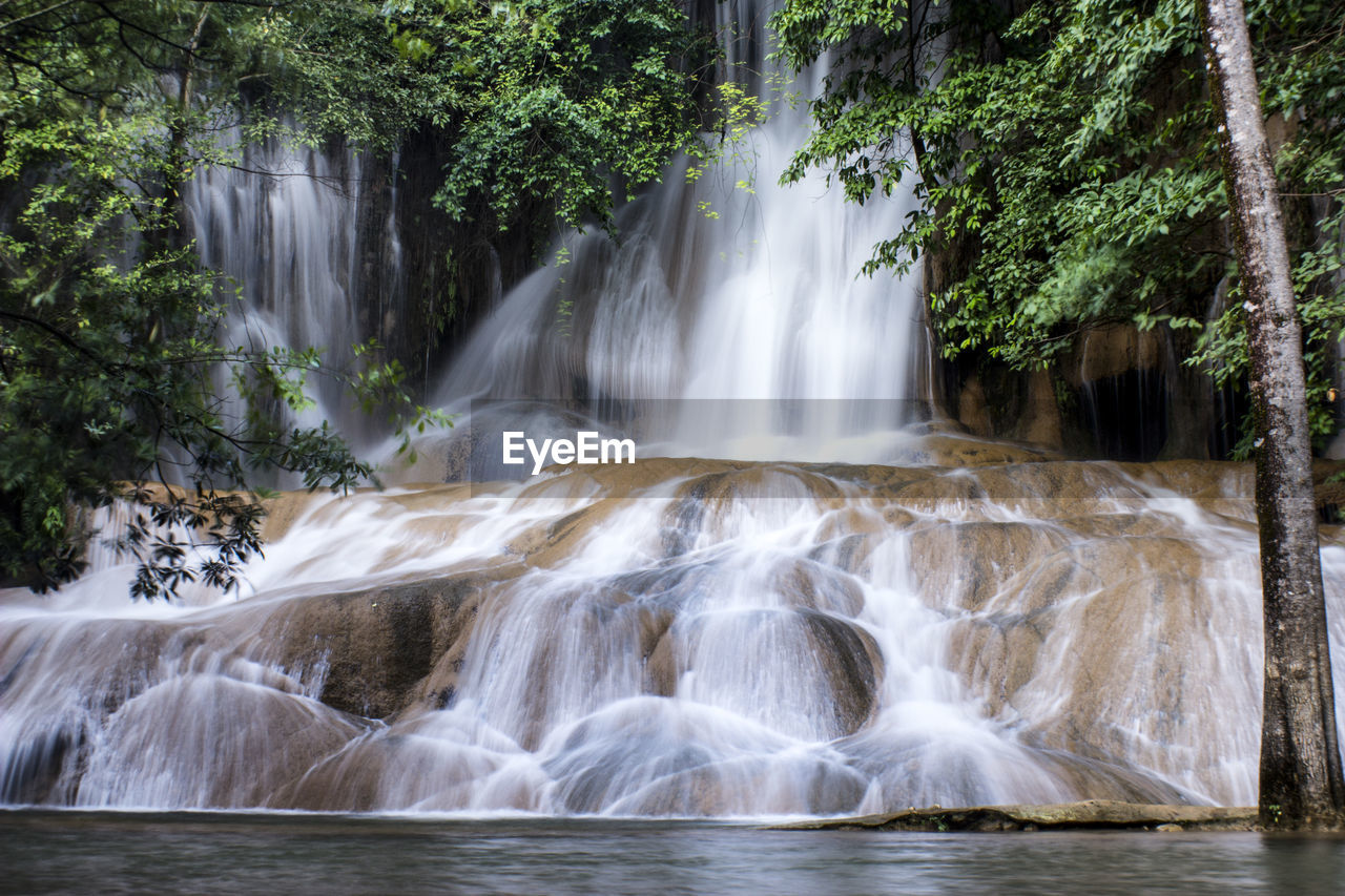 water, waterfall, beauty in nature, scenics - nature, tree, body of water, plant, environment, nature, forest, watercourse, land, motion, water feature, river, stream, travel destinations, landscape, outdoors, no people, long exposure, water resources, rainforest, tropical climate, flowing water, tourism, rock, travel, flowing, social issues, idyllic, non-urban scene, environmental conservation