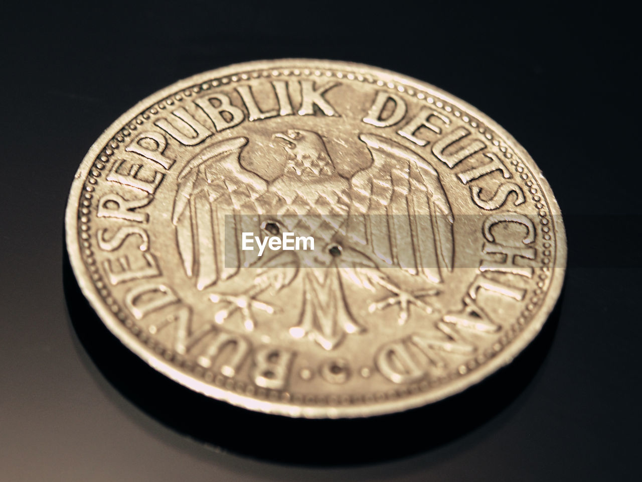 Close-up of bundesadler coin on table