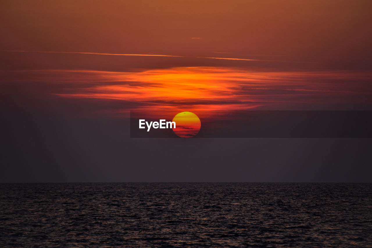 SCENIC VIEW OF SUNSET OVER SEA