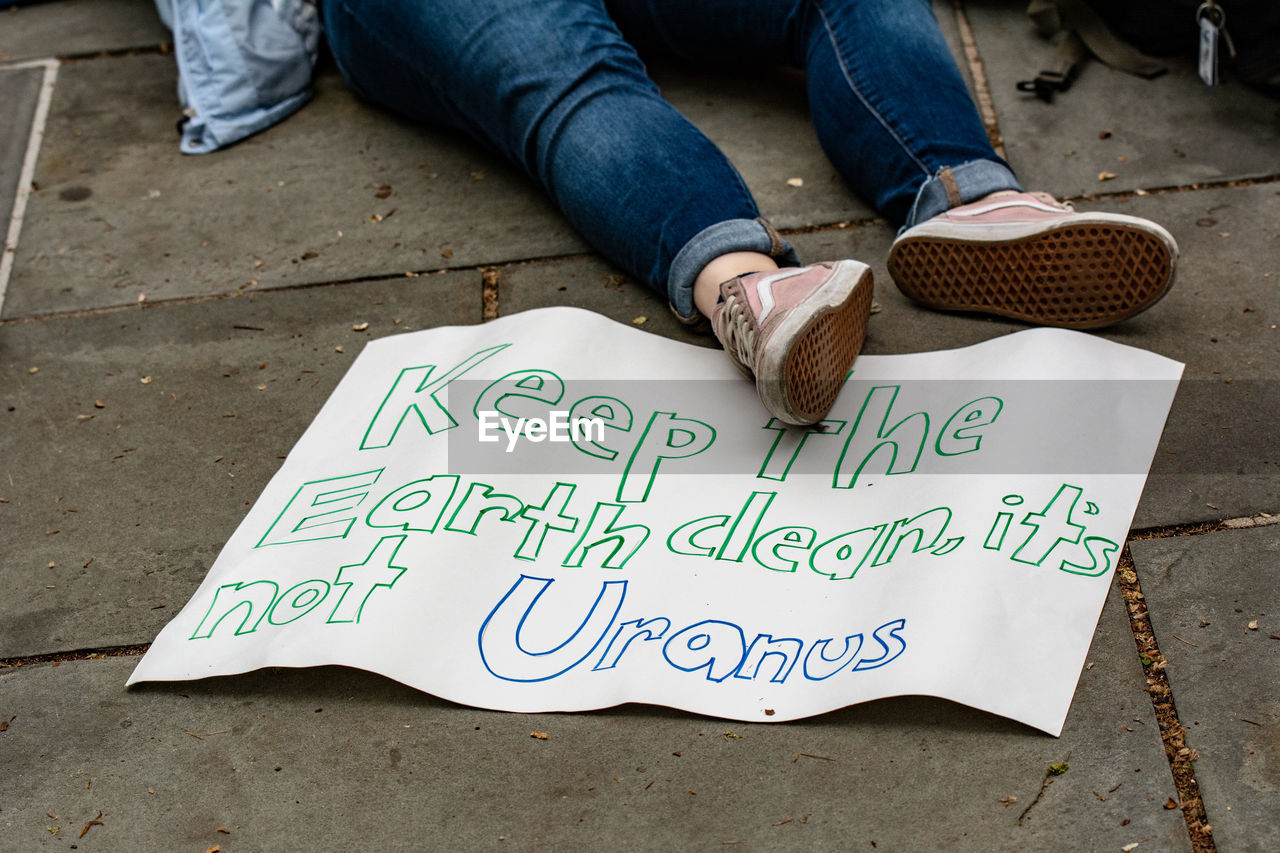 LOW SECTION OF MAN HOLDING PAPER WITH TEXT