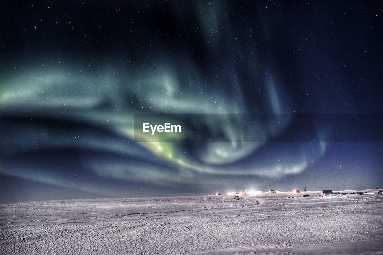 View of snowcapped landscape and northern lights