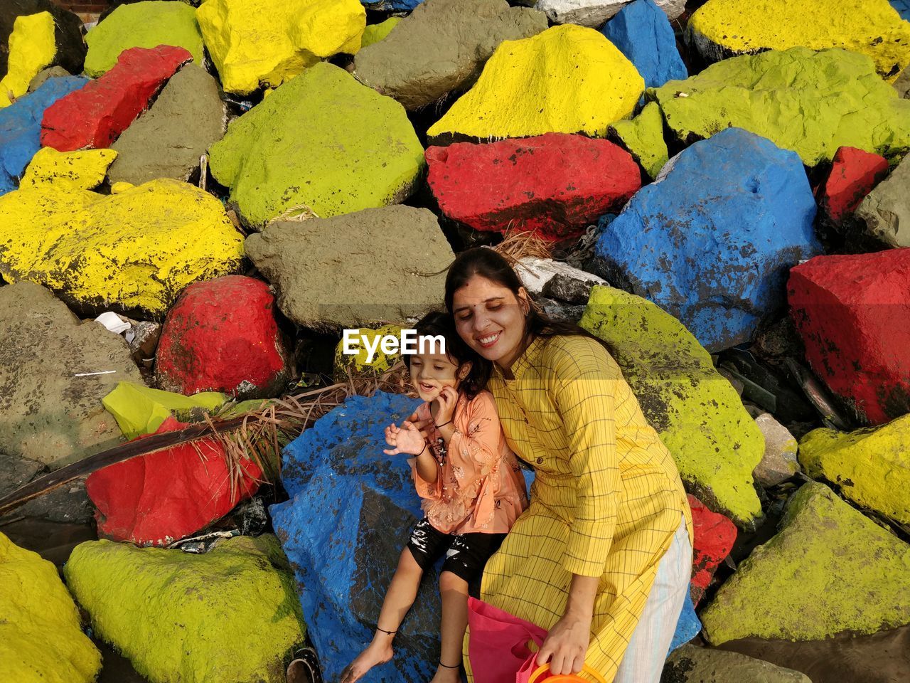 PORTRAIT OF A SMILING YOUNG WOMAN WITH UMBRELLA