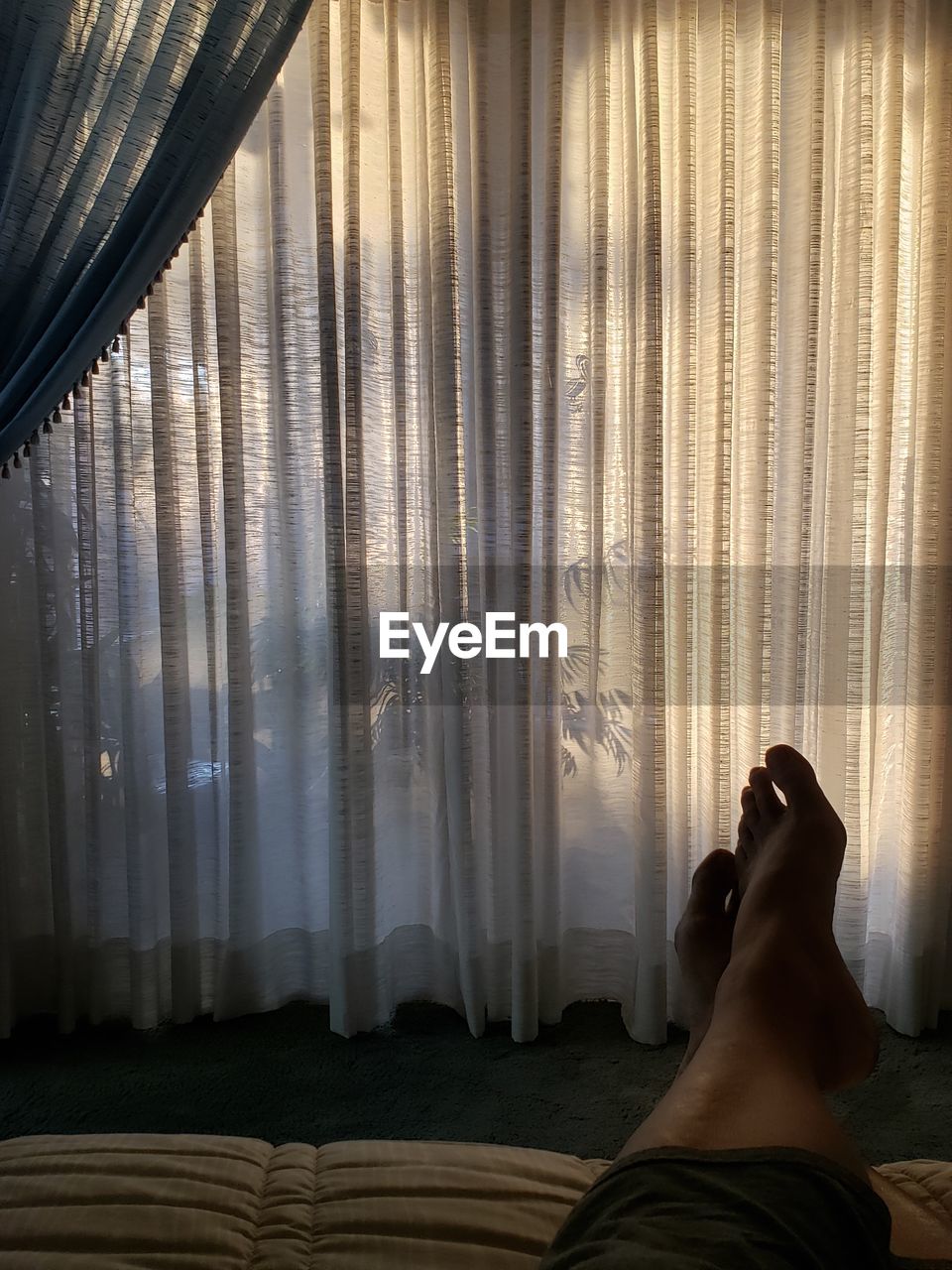LOW SECTION OF WOMAN ON WINDOW