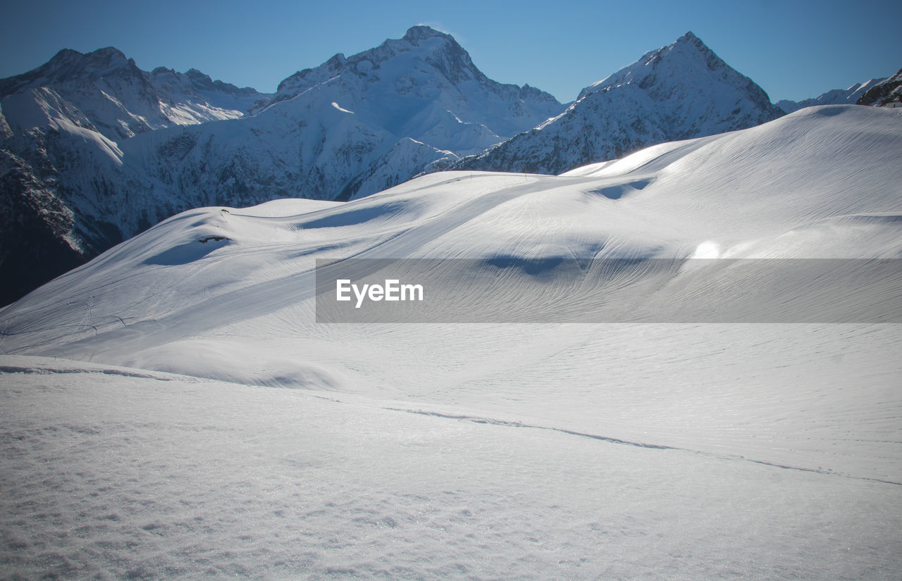 Scenic view of snow covered mountains against sky