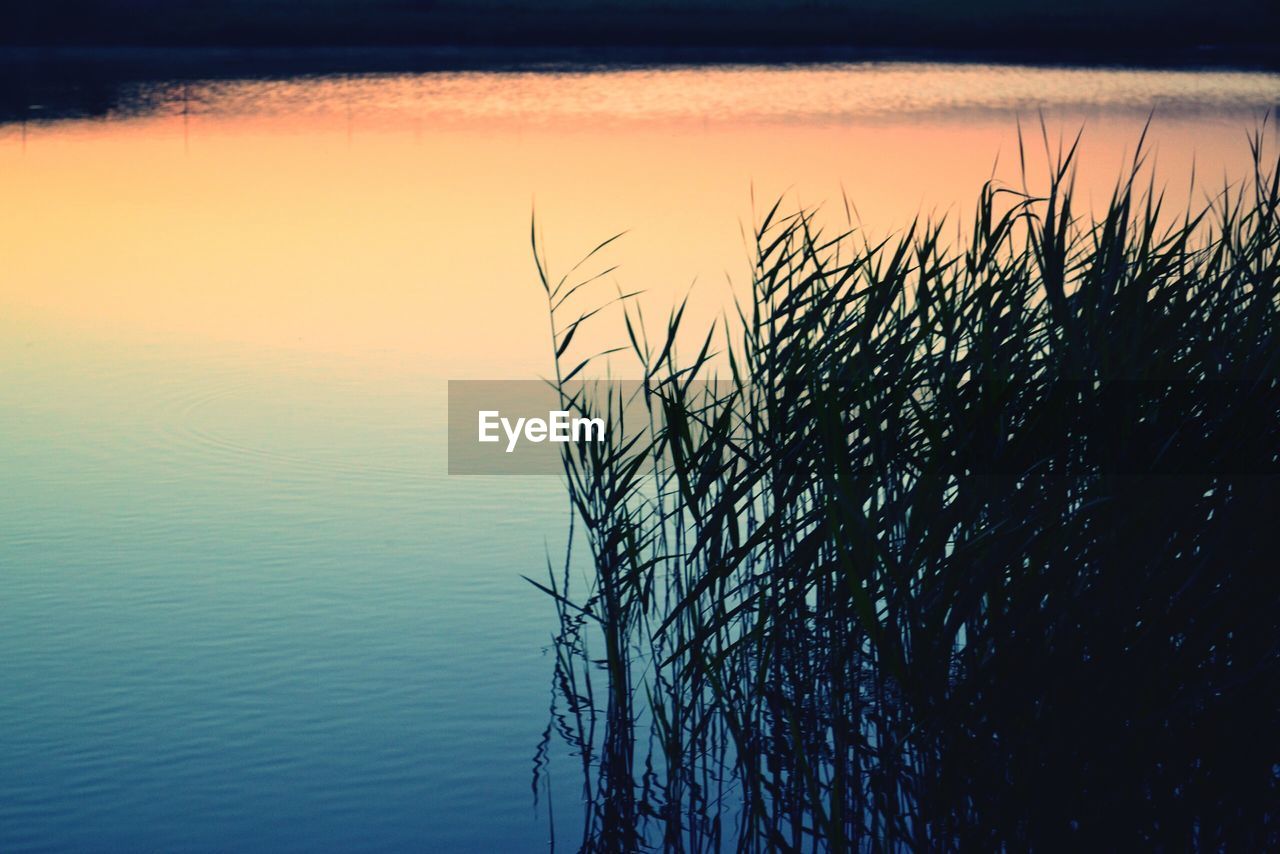 SCENIC VIEW OF LAKE AT SUNSET