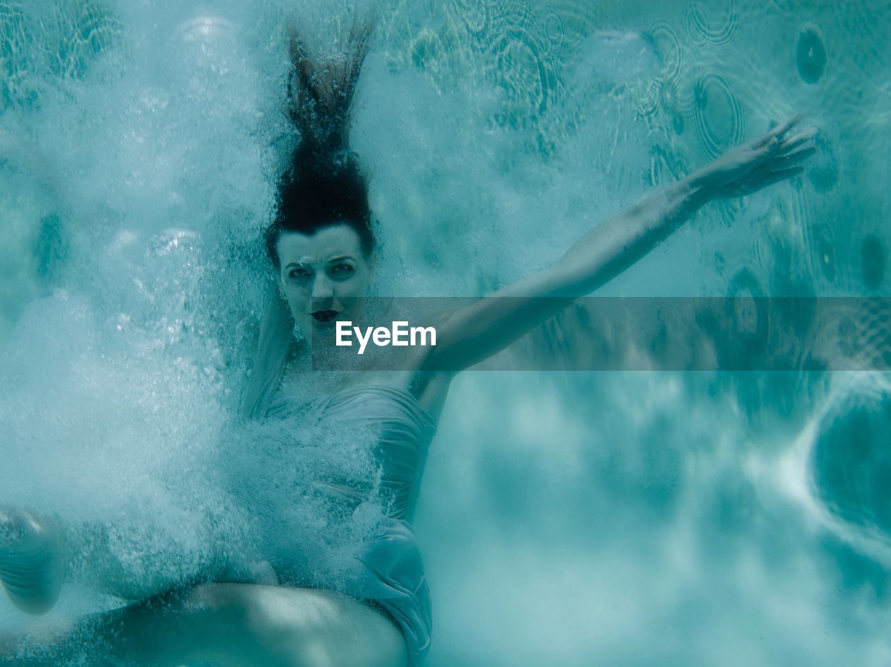 Portrait of young woman swimming in pool