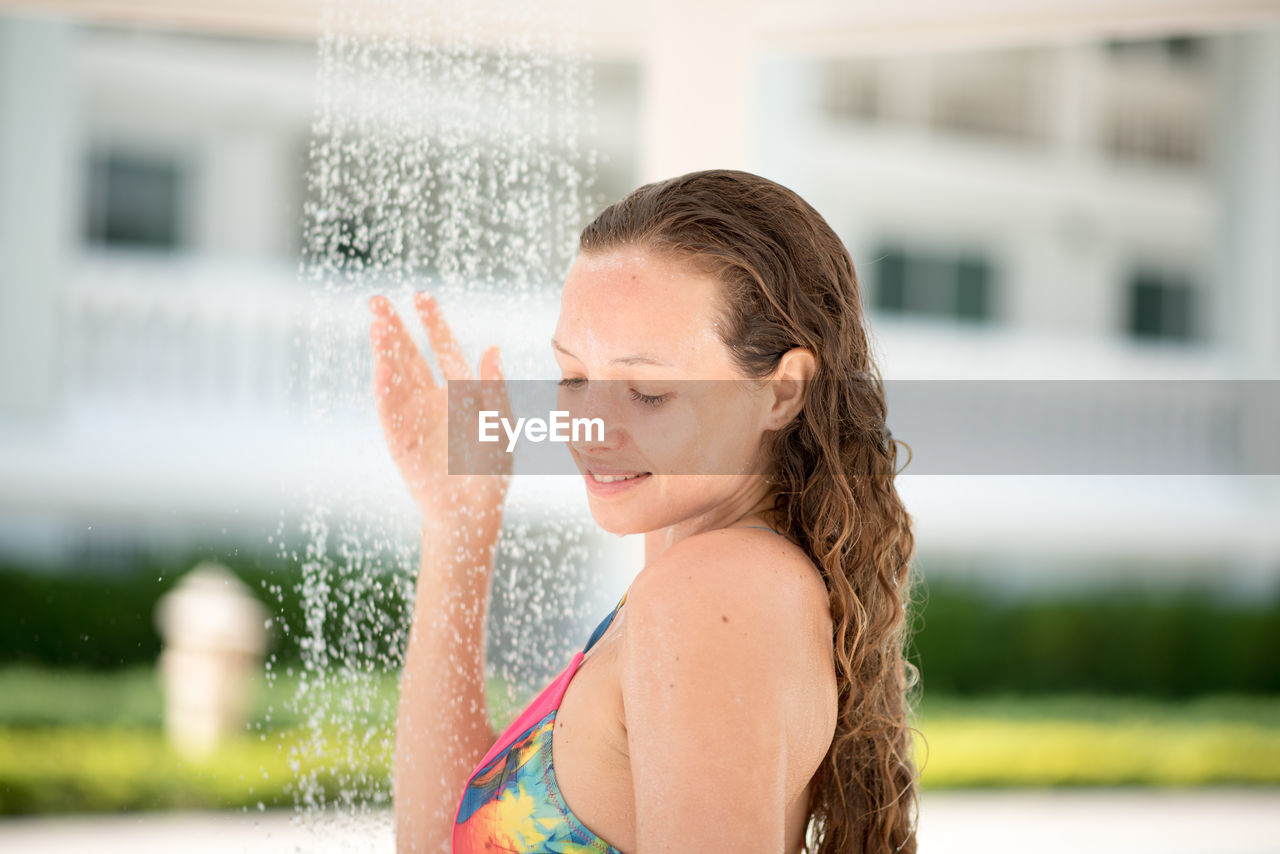 Woman taking shower outdoors