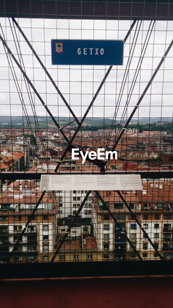 VIEW OF BUILDING THROUGH WINDOW