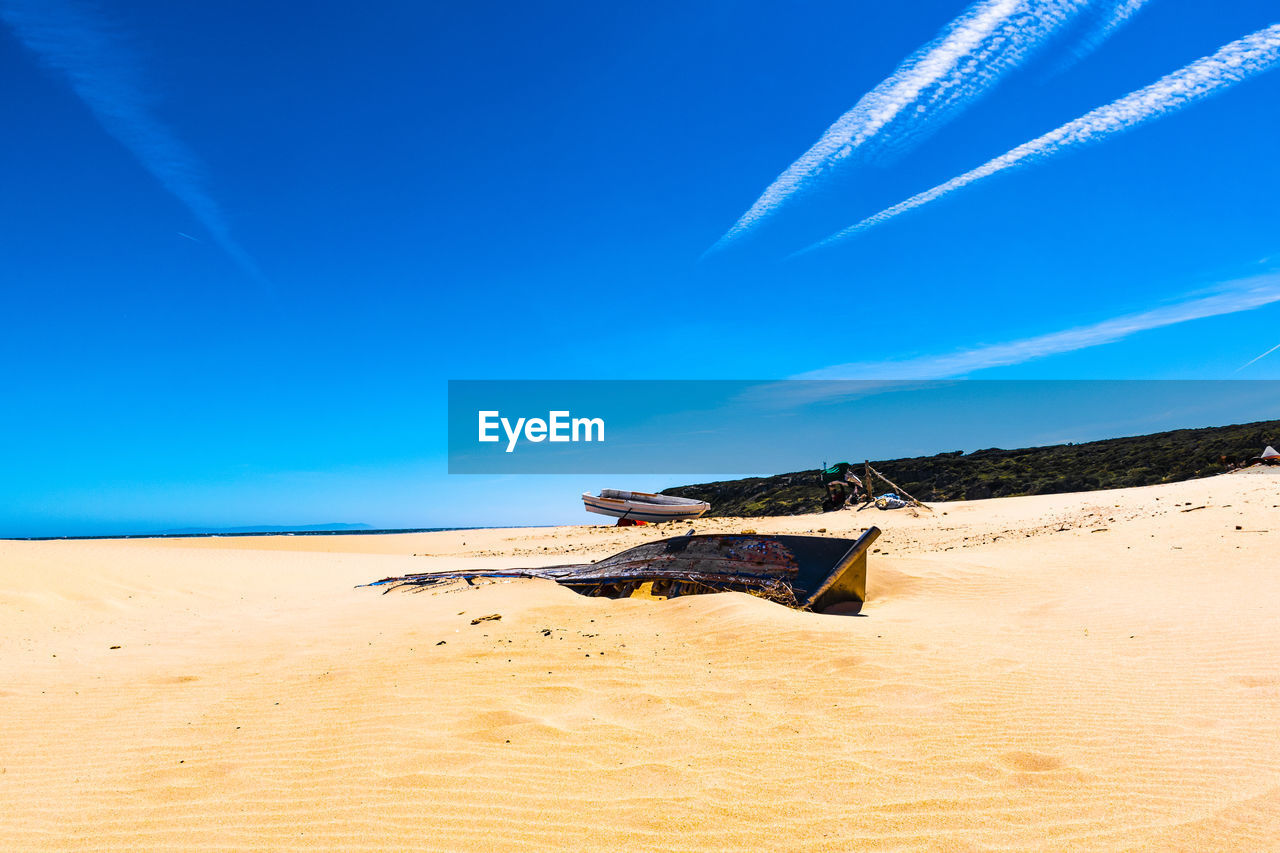 Scenic view of desert against blue sky