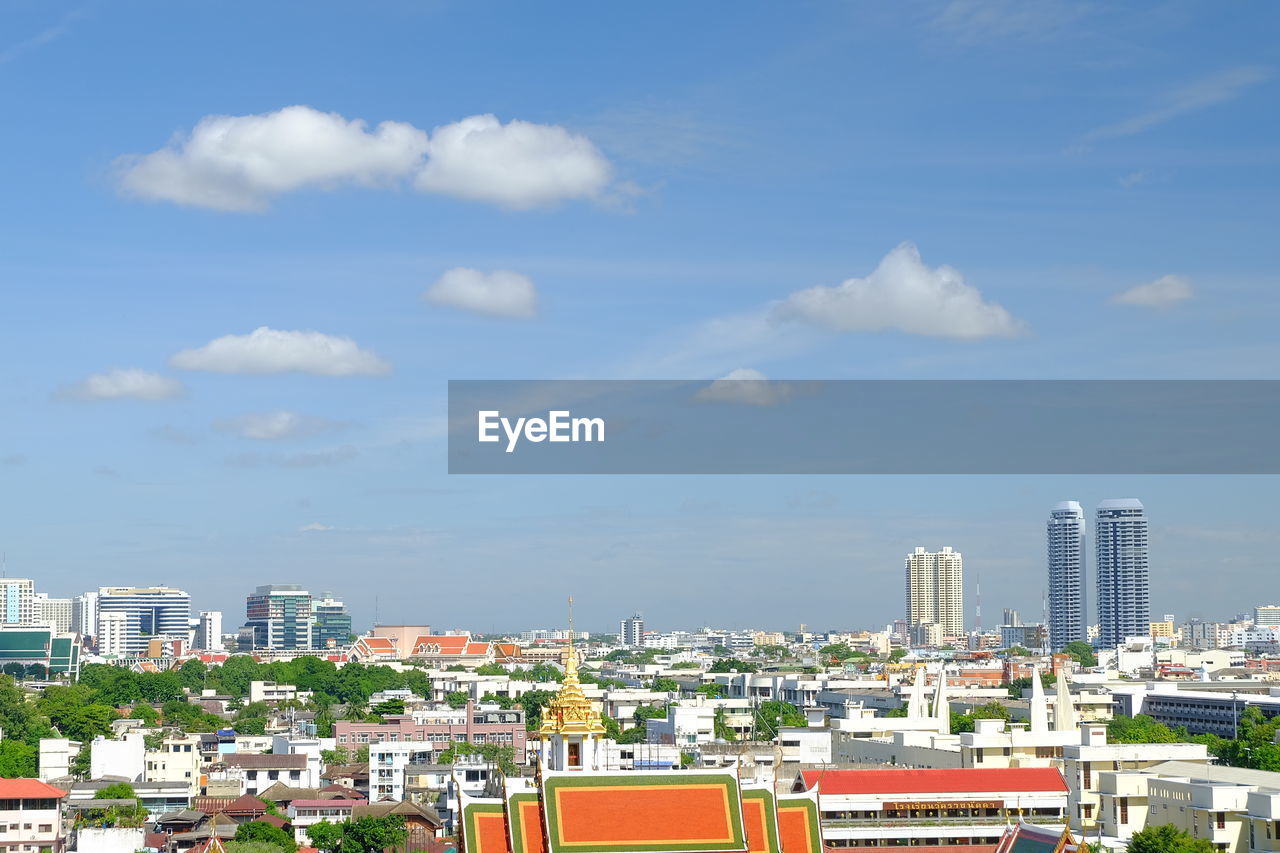 Buildings against cloudy sky