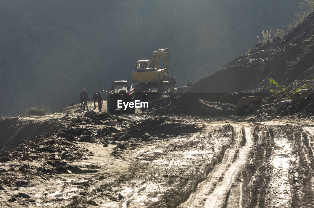 Worker and construction vehicle at mining site