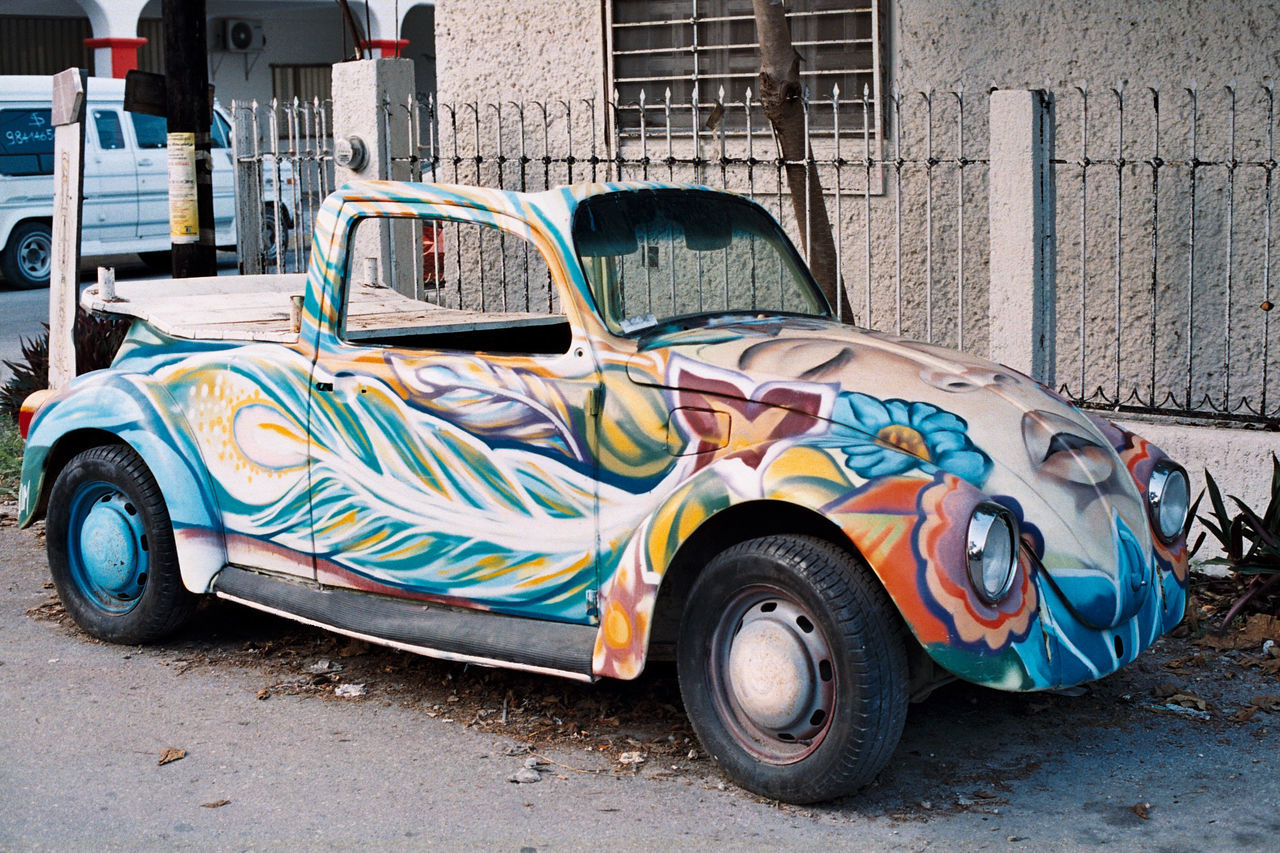 VINTAGE CAR PARKED ON CITY STREET