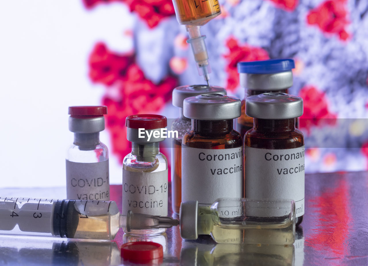 In this photo illustration, vials labelled as coronavirus vaccine and a syringe