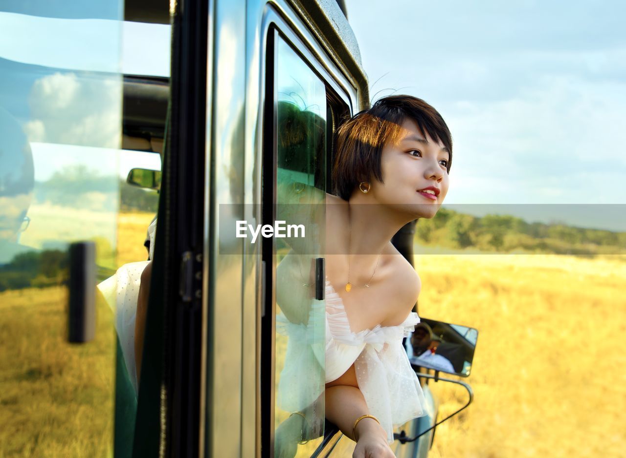 Close-up of woman looking through car window