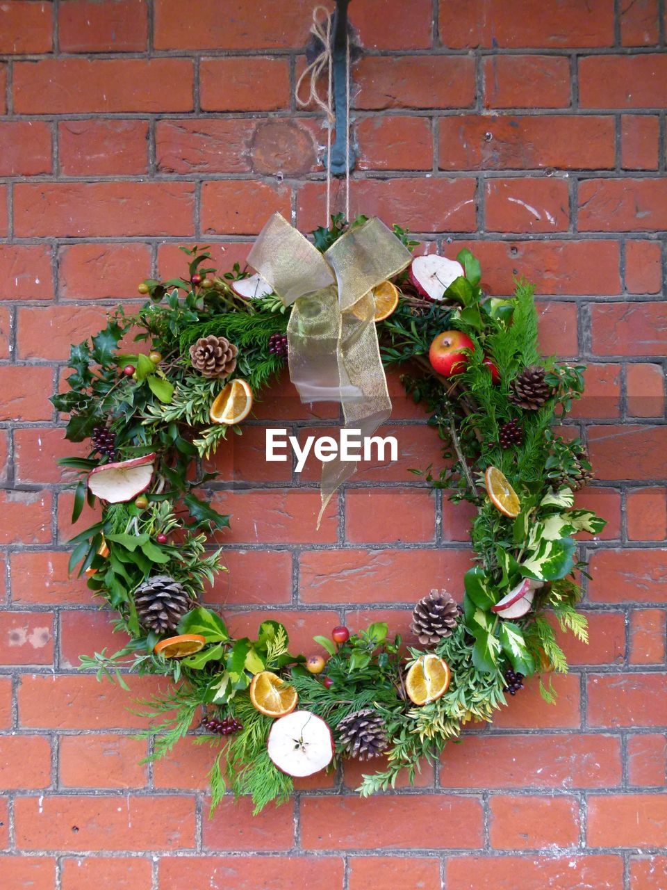 Wreath hanging on brick wall