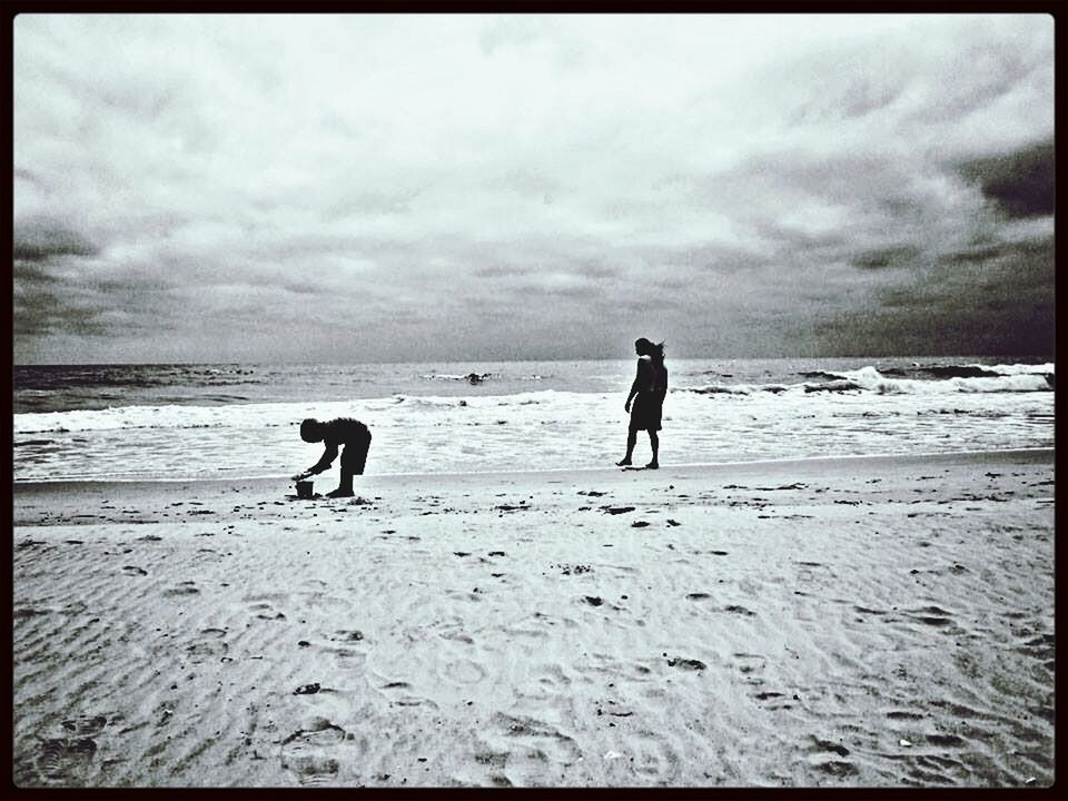 VIEW OF BEACH AGAINST CLOUDY SKY