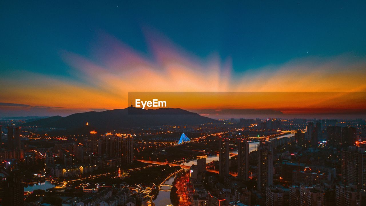 High angle view of illuminated buildings against sky during sunset