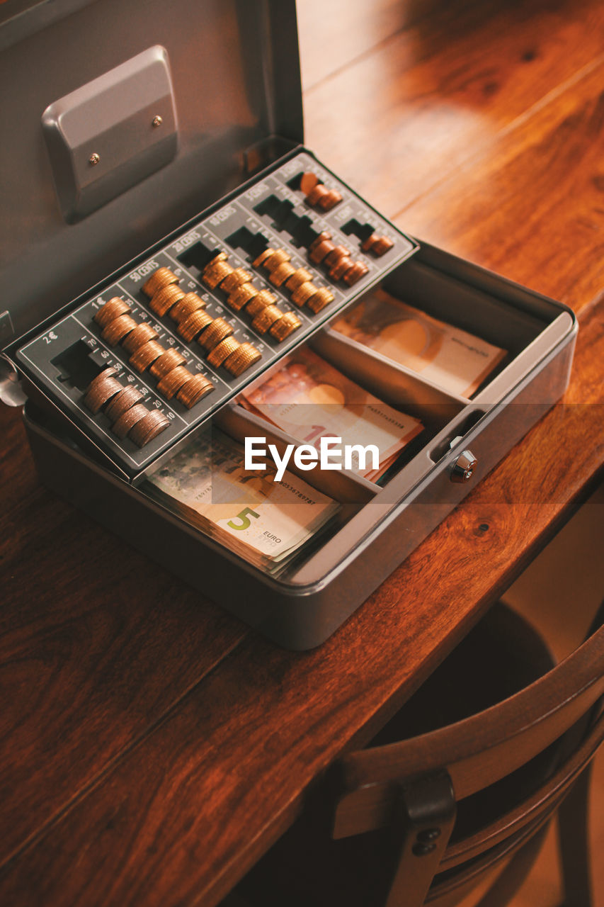 High angle view of currency in box on table