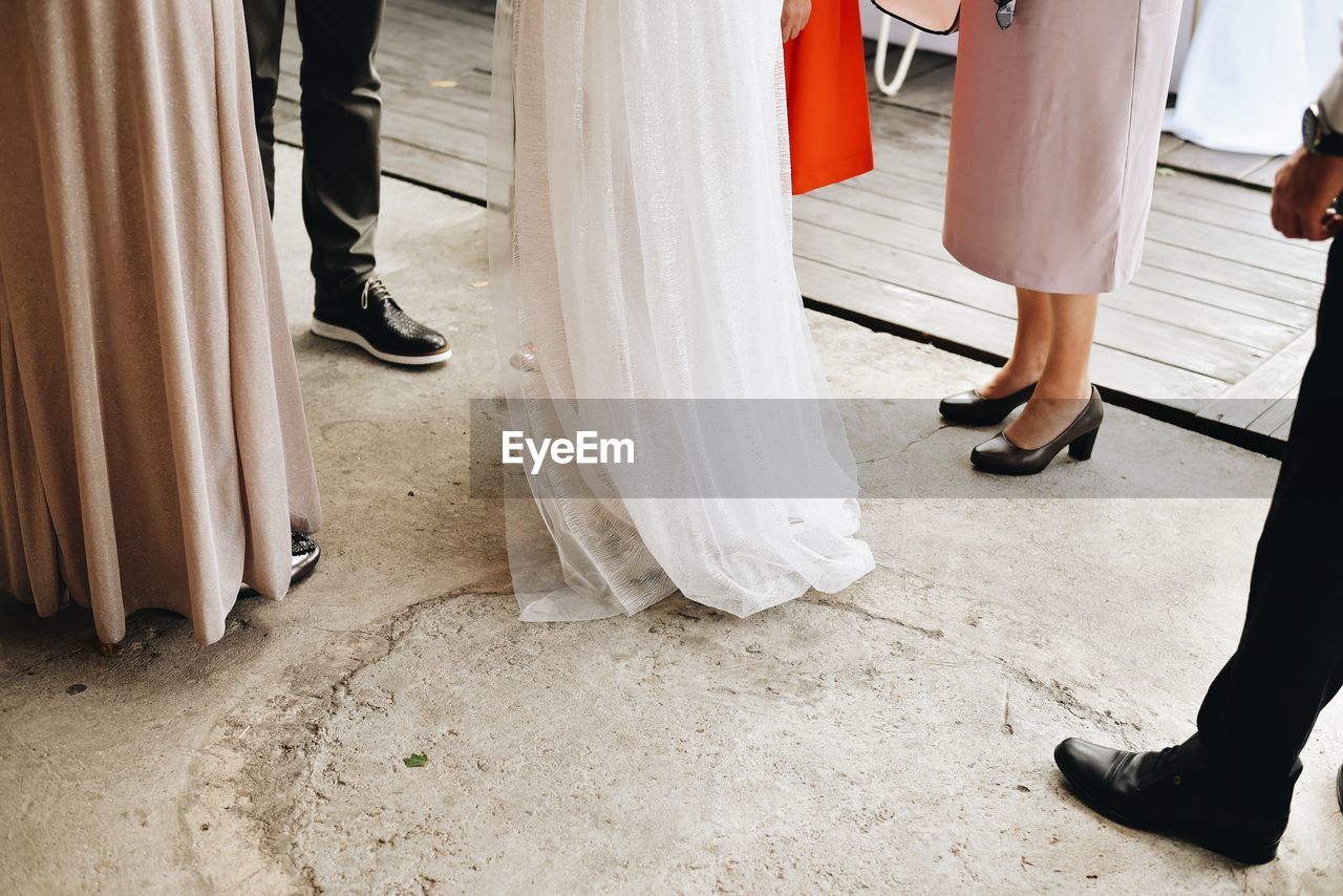 Low section of people at wedding party standing on floor