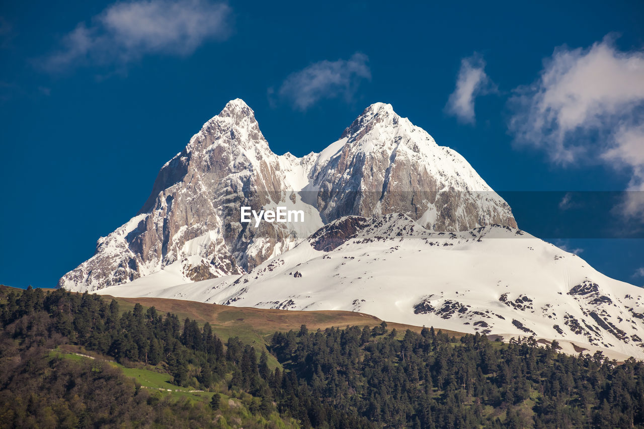 SCENIC VIEW OF SNOWCAPPED MOUNTAINS AGAINST SKY DURING WINTER