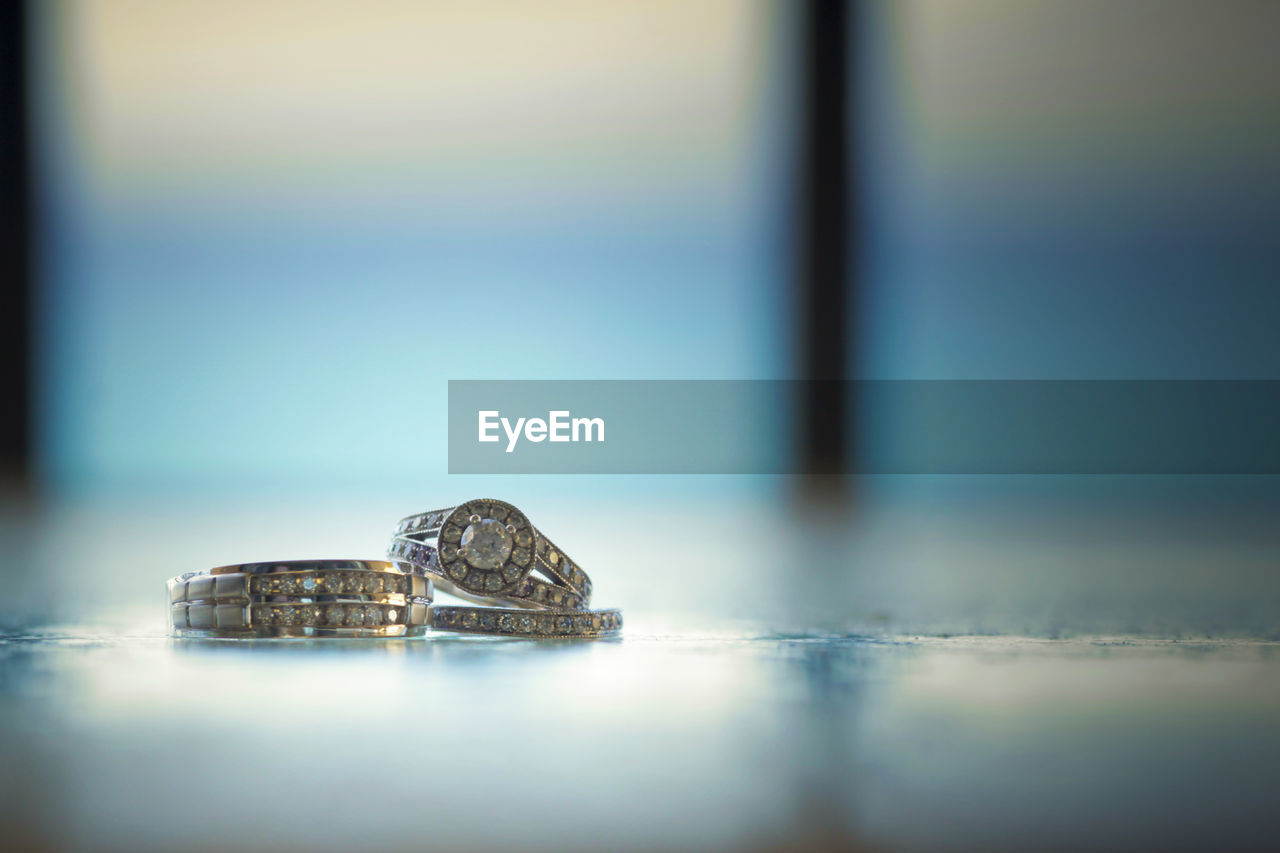 Close-up of wedding rings on table