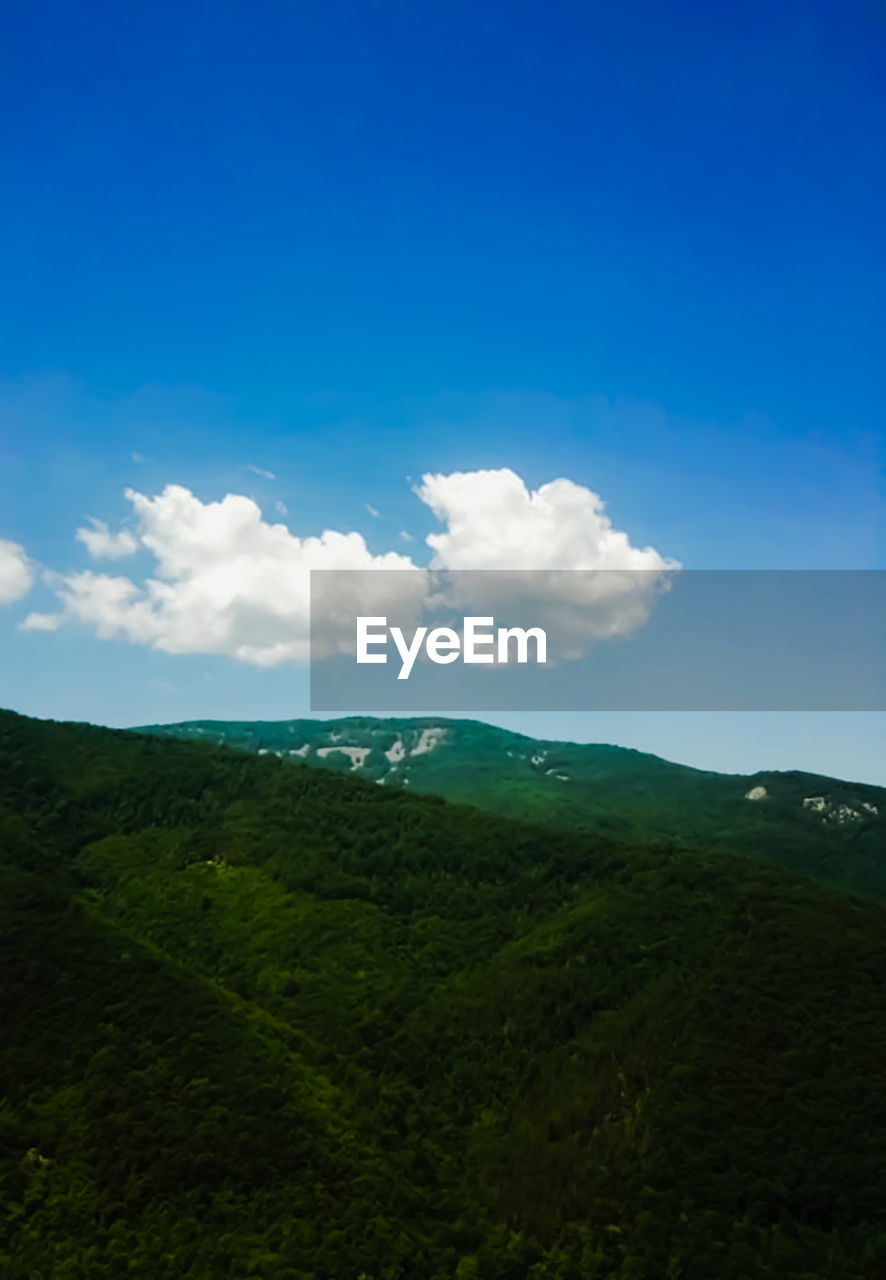 SCENIC VIEW OF LANDSCAPE AND MOUNTAINS AGAINST SKY