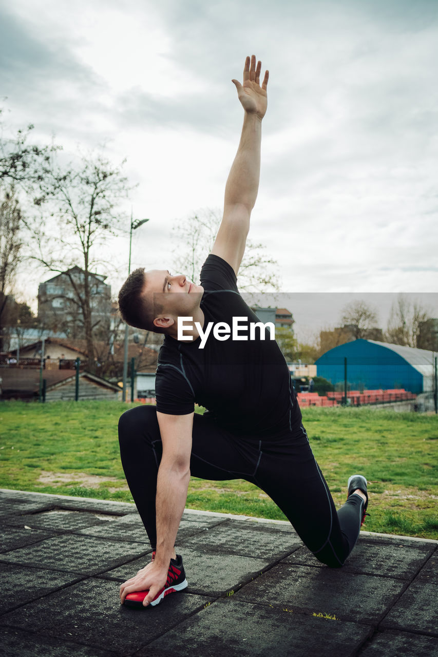 Full length of man exercising at park