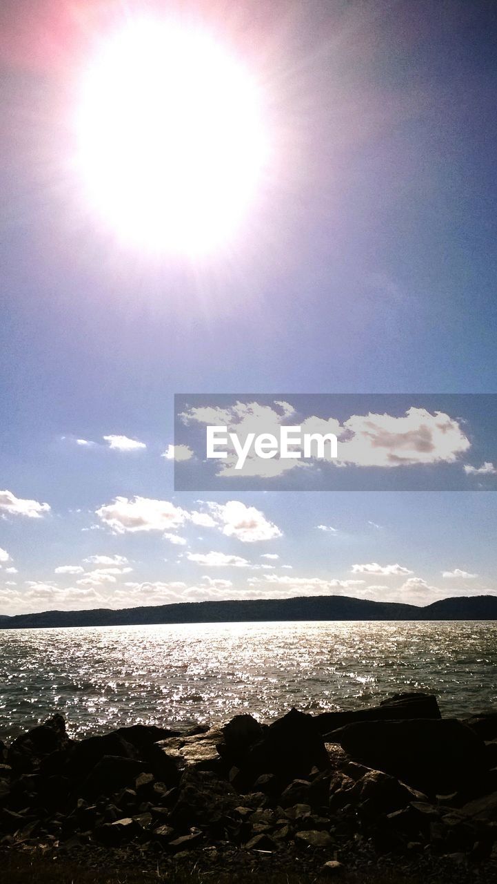 Bright sun over calm lake