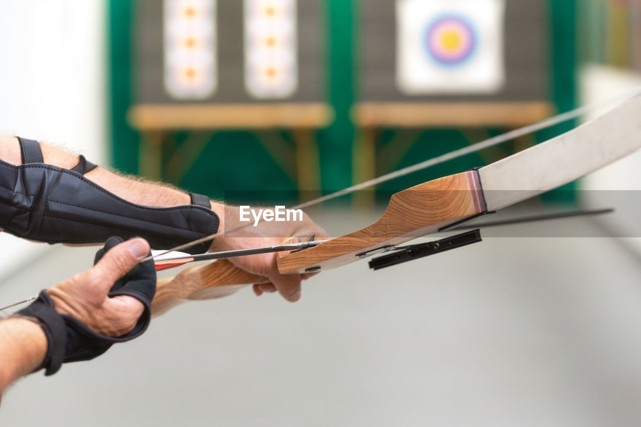 Close-up of man holding bow