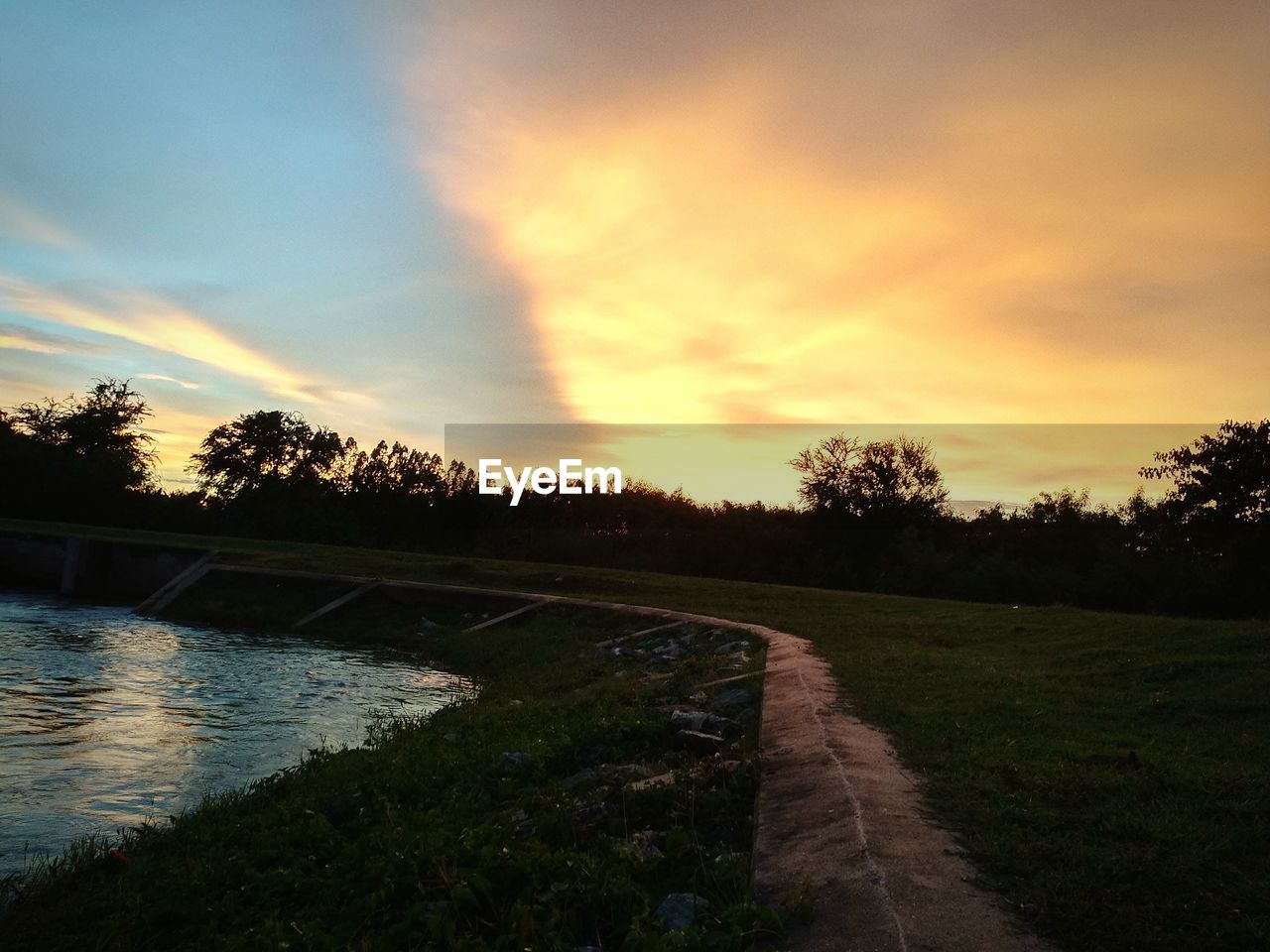 VIEW OF SWIMMING POOL AGAINST SKY AT SUNSET