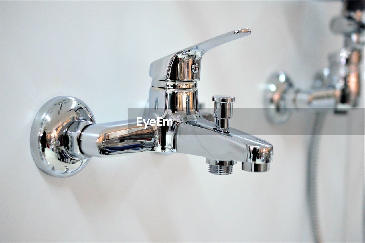 CLOSE-UP OF FAUCET ON BATHROOM