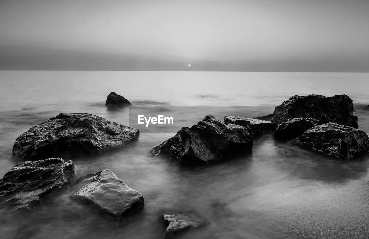 High angle view of rocks at sea against clear sky