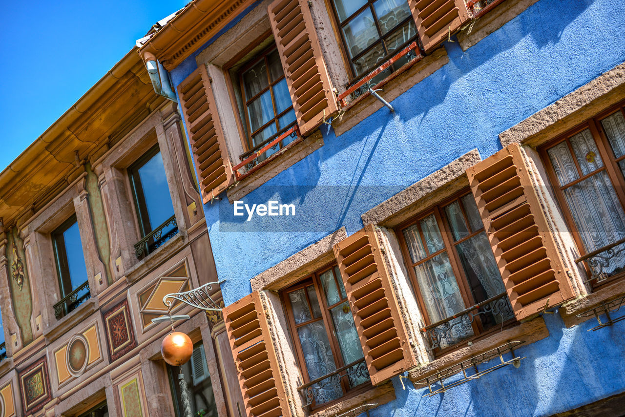 Low angle view of old building against blue sky