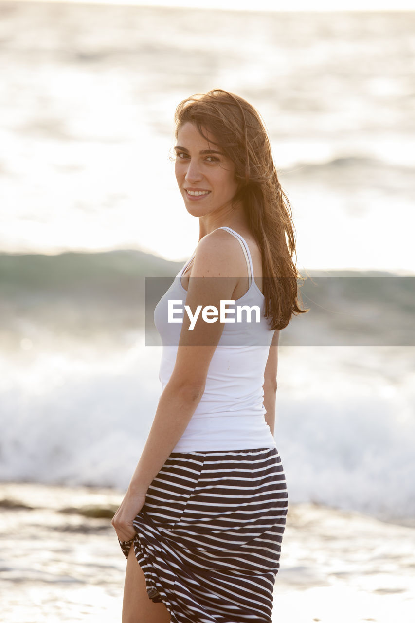 BEAUTIFUL WOMAN STANDING ON BEACH