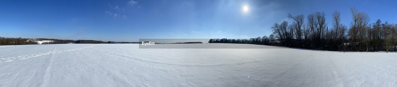 Snow covered landscape against sky