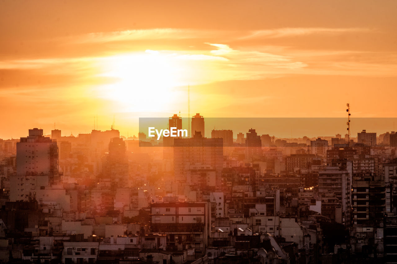 Cityscape against sky during sunset