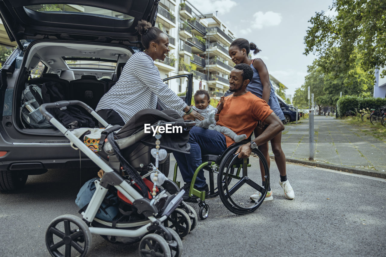 Happy family on road by car