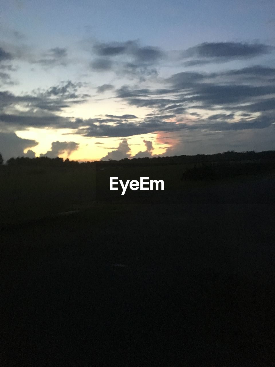 SCENIC VIEW OF SILHOUETTE LANDSCAPE AGAINST SKY AT SUNSET