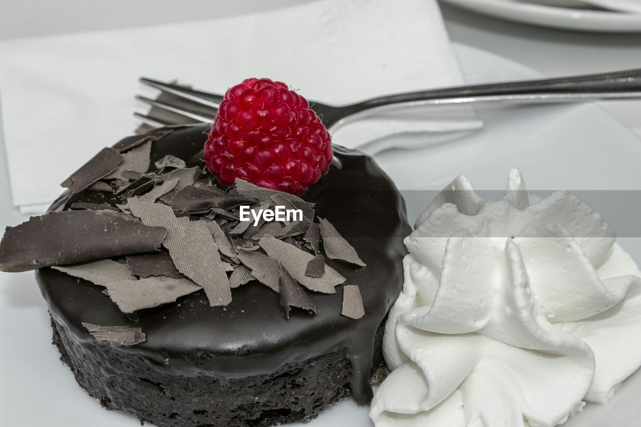 Close-up of cake and whipped cream on plate